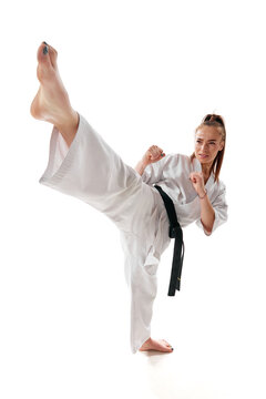 Master black belt Tae Kwon Do fighter in uniform show high kick pose isolated over white background.