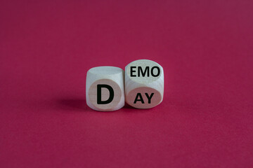 Demo day symbol. Fliped wooden cubes with concept words demo day on a beautiful red background....