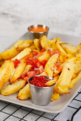 French fries on a plate with sauces