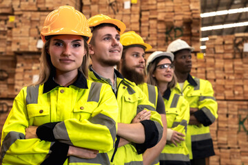 Group of young diverse men and women wood industrial workers in pallet wooden distribution warehouse