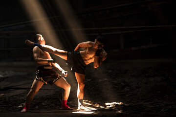 Muay Thai boxers doing kickboxing in the dark