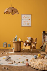 Warm and cozy kid room interior with mock up poster frame, yellow wall, orange armchair, plush toys, wooden block toys, coffee table, plaid, cup and personal accessories. Home decor. Template.