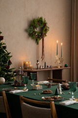 Christmas composition of dining room interior with family table, christmas tree, furniture, decoration, stars, gifts, accessories, deer, candlestick, candle and hanging wreath. Home decor. Template.