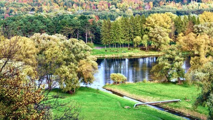 Fototapeta na wymiar Beautiful autumn landscape with river and forest in Carpathian mountains, Sanok, Poland.