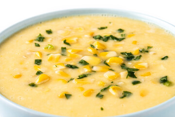 Corn soup in green bowl isolated on white background. Close up