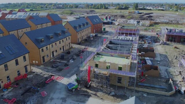 Drone 50fps. New build houses. Affordable housing development, construction site, new modern family houses. Filmed. Northern England. UK.