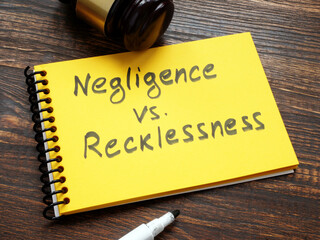 Negligence vs recklessness inscription and a gavel.