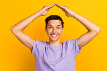 Portrait of nice attractive cheerful guy showing roof over head flat isolated over vibrant color background