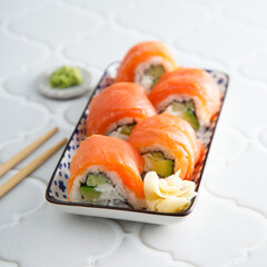 Salmon sushi rolls with cucumber and avocado