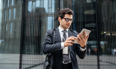 A friendly real estate agent manager person writes a message using the internet and a tablet on a...