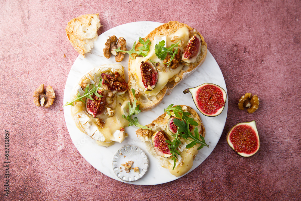 Sticker Baked camembert cheese with figs and honey on toast