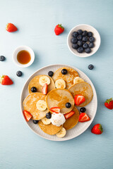 Homemade pancakes with banana and berries