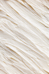 Close-up of delicious, sweet, organic cream with textured waves. Sweet cream for cakes and desserts. Healthy eating. Concept of food texture, organic products, cooking. Background, wallpaper, poster