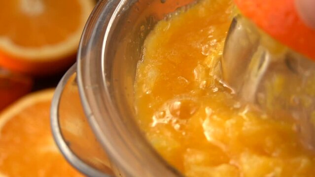 Super close-up of the orange juice squizzed from the half of an orange