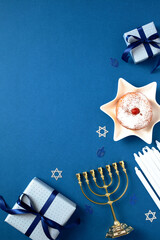 Hanukkah Jewish holiday vertical background with gold menorah, gift boxes, candles, traditional...