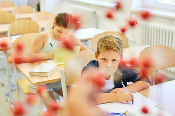 Schoolkid looking at molecular structure in classroom