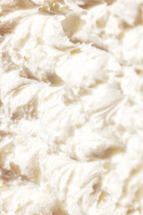 Close-up of delicious, sweet, organic cream with textured waves. Sweet cream for cakes and desserts. Concept of food, breakfast, healthy eating and snacks, organic, homemade products