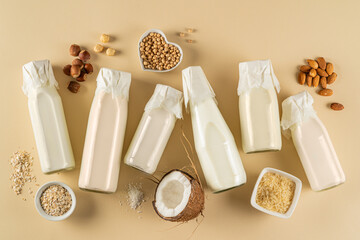 Plant based milk concept - selection of alternative milks on pastel background