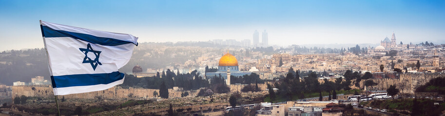Jerusalem panorama with waving flag of Israel over the old walls of holy land. Cityscape of...