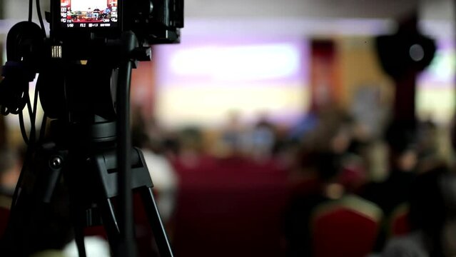 The press is filming a video of the conference in the hall