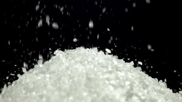 Salt crystals fall into a pile. Filmed on a high-speed camera at 1000 fps. High quality FullHD footage