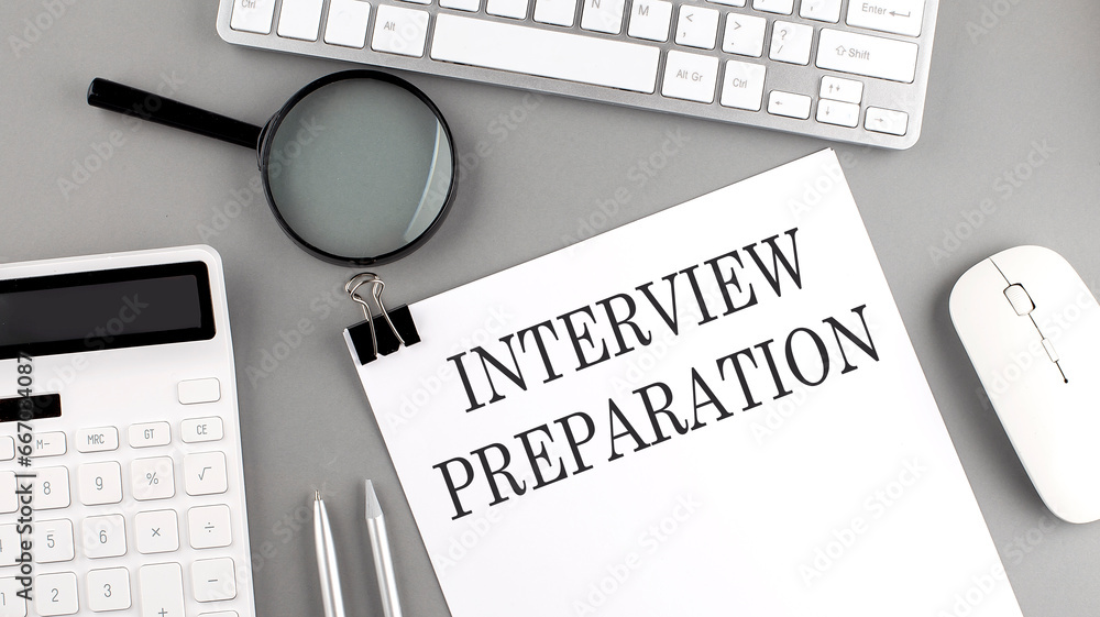 Poster interview preparation written on paper with office tools and keyboard on the grey background