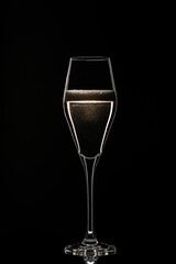 Backlit wine champagne glass with golden liquid