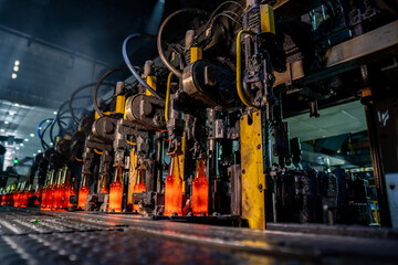 Production of glass bottles and glass containers. The heated glass bottles melted from quartz sand...