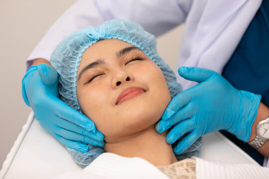 Professional and compassionate Asian doctor providing expert skincare advice to patient. The attentive consultation takes place in a well-lit and modern medical office, ensuring the highest quality.