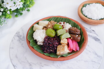 Jenang Madura is a typical Indonesian food that consists of black sticky rice, porridge marrow, jenang grendul and red pearls that were given palm sugar and coconut milk