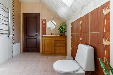 Fototapeta na wymiar A spacious bathroom with heated floors, a separate bathroom, shower, double shell and windows