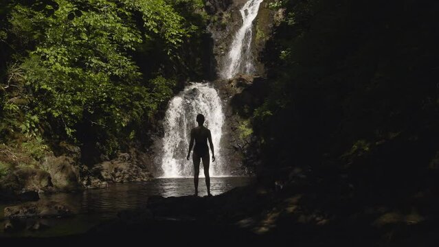 Woman Stands in Front of Rha Waterfall on Isle of Skye Scotland 4K
