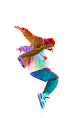 Sportive, stylish young man in sportswear dancing street style dance isolated over white studio background in neon light. Concept of contemporary dance, street style, fashion, hobby, youth. Ad