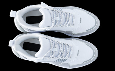 White running shoes. Sport sneakers isolated on black background. A casual, comfortable pair of beige shoe. A new and fashionable pair of sneaker. Cutout