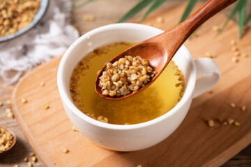 cup of buckwheat tea on wooden table