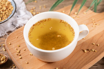 cup of buckwheat tea on wooden table