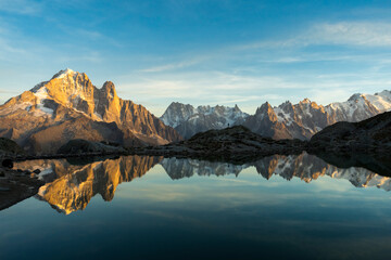 Silhouette of Man, Mountains and Reflection in Lac Blanc Lake at Sunset. Golden Hour. Chamonix,...