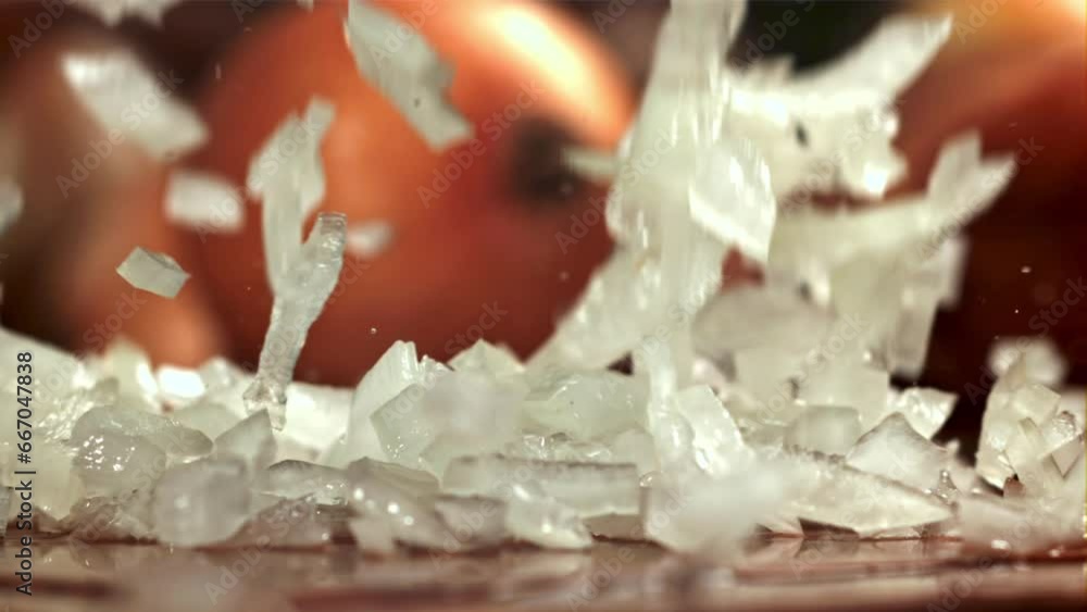 Wall mural Chopped onions fall on the cutting board. Filmed on a high-speed camera at 1000 fps. High quality FullHD footage