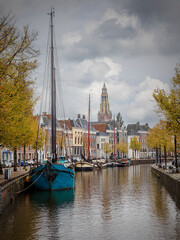 Groningen, the capital of the province of Groningen, with the many beautiful canals and houseboats, and in the background the famous Martini tower.