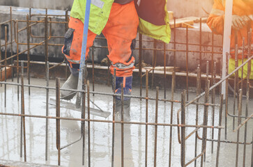 Concrete cast-in-place work. Builder level wet concrete. Concrete works on buildiiing construction site