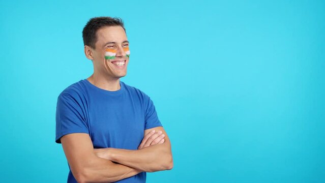 Happy man with indian flag painted on face looking away