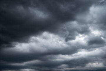 Obraz premium dark clouds make sky in black. Heavy rain thunderstorm. Pattern of clouds overcast predict tornado, Hurricane or thunderstorm and rainy. Dark sky cloudy have storm and lightning thunderbolt.