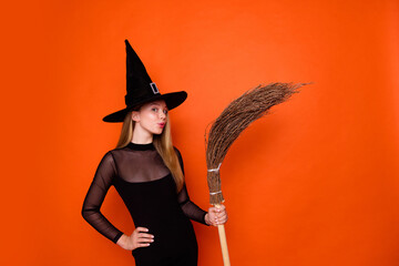 Photo portrait of pretty blonde teenager girl hold broom pouted lips dressed black halloween outfit...