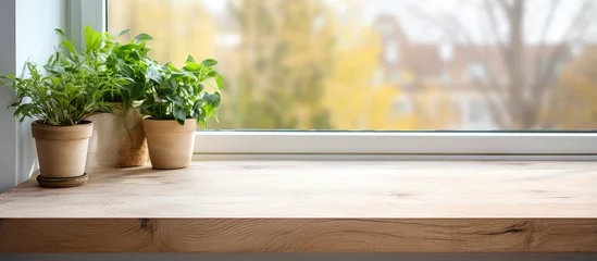 Fotobehang Installing a wooden window sill covered with oak veneer related to interior design and home improvement © Vusal