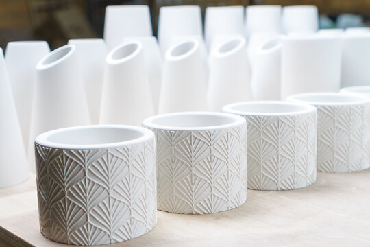 Making and casting decorative dishes and vases from plaster for home decoration in the workshop. successful micro-enterprise in the crafts and home decor industry.