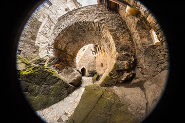 passage in a medieval castle seen with a fisheye lens