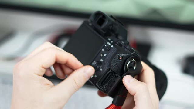The man removes the memory card from the camera photo. Close-up of hands and equipment.