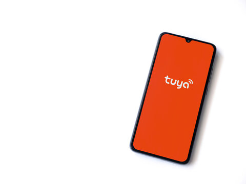 Lod, Israel - July 16,2023: Tuya Smart app launch screen on smartphone on white background. Top view flat lay with copy space.