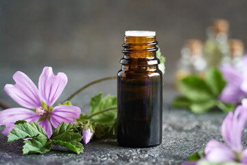 A bottle of mallow essential oil on a table