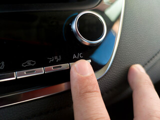 Driver activating the car air conditioning system